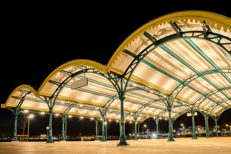 a large covered structure with lights and poles