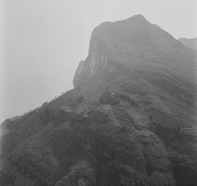 a tall mountain covered in fog and smog