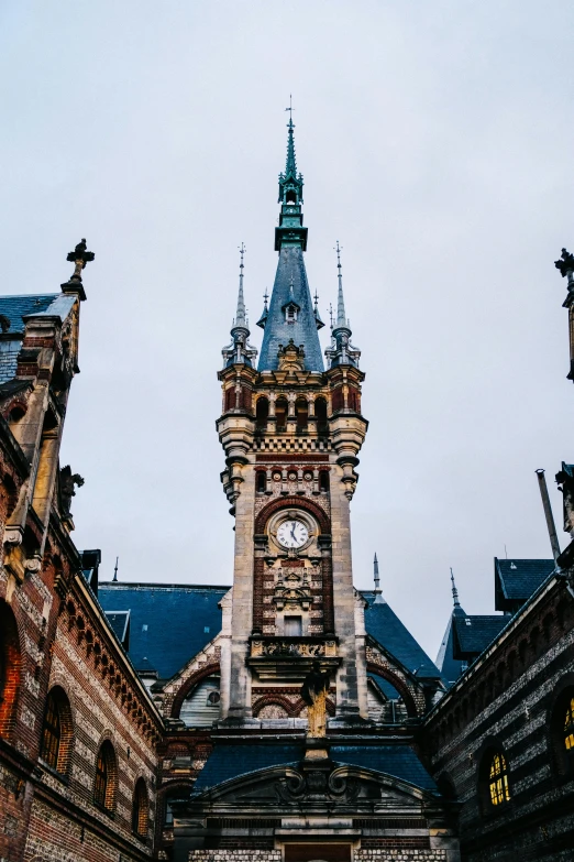 a large clock tower stands over some buildings