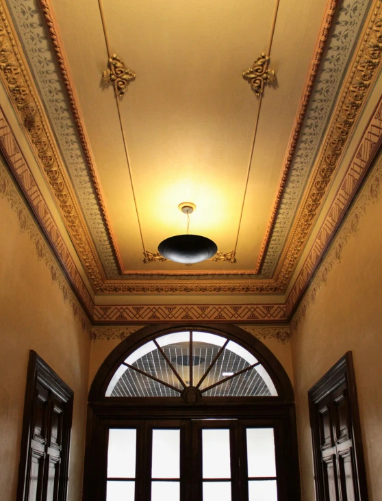 the ceiling is decorated in gold and has ornate details