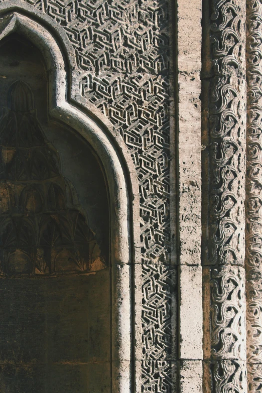 this is an intricate carved window next to the door