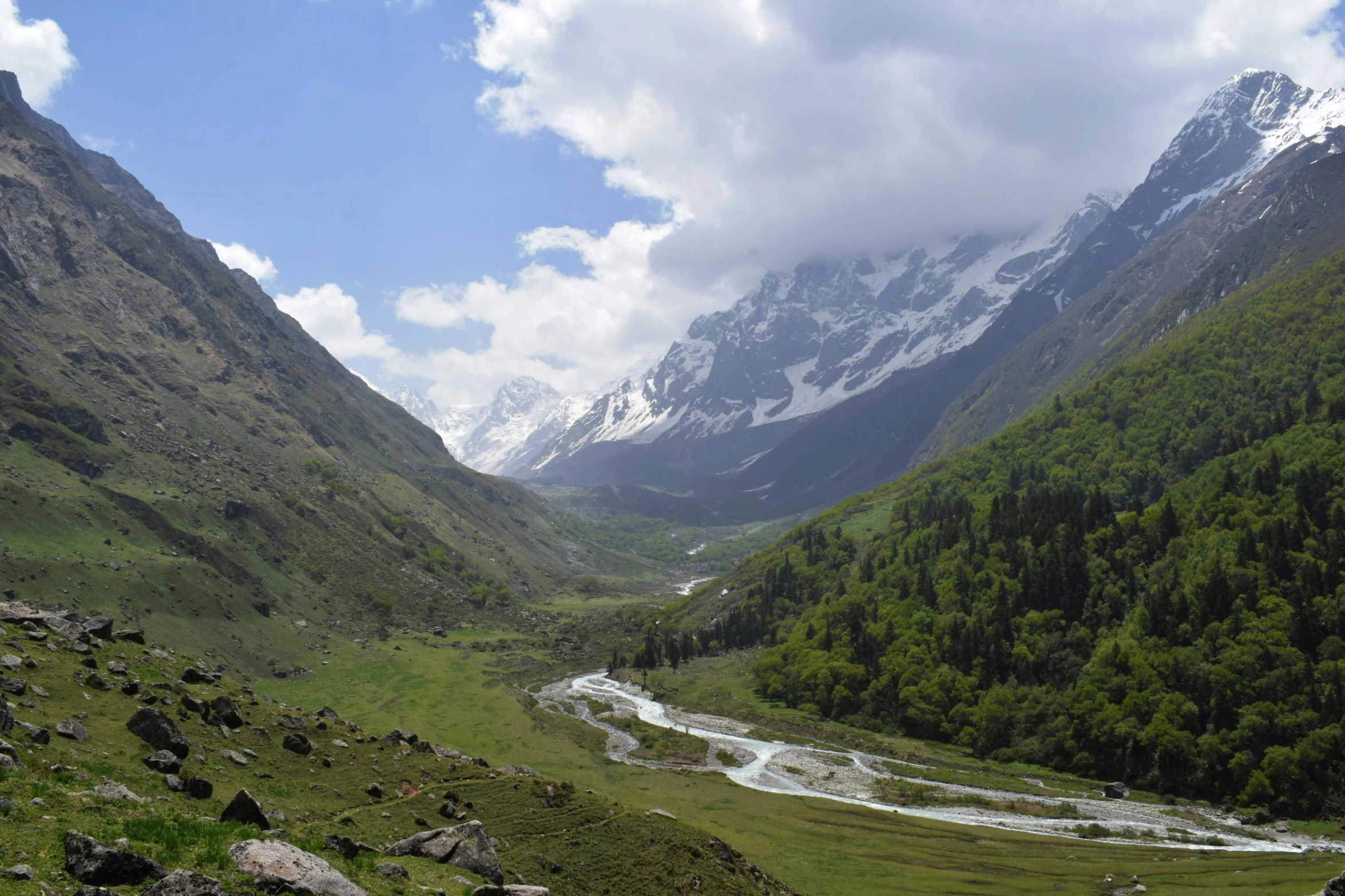 mountains with snow and river running through them