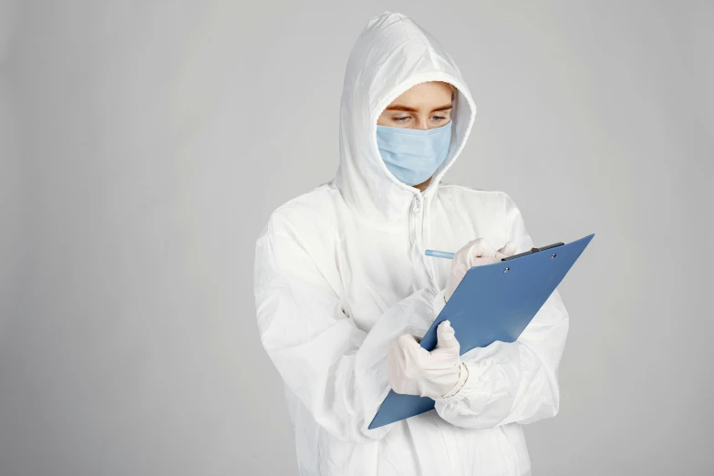 a female in white medical gown holding a blue file