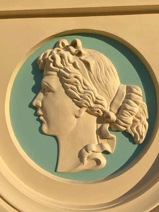 a plaque with the profile of a female head