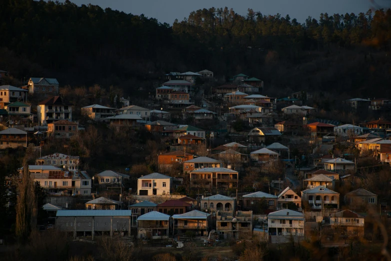 the town is full of tall houses, and there are lights on the buildings