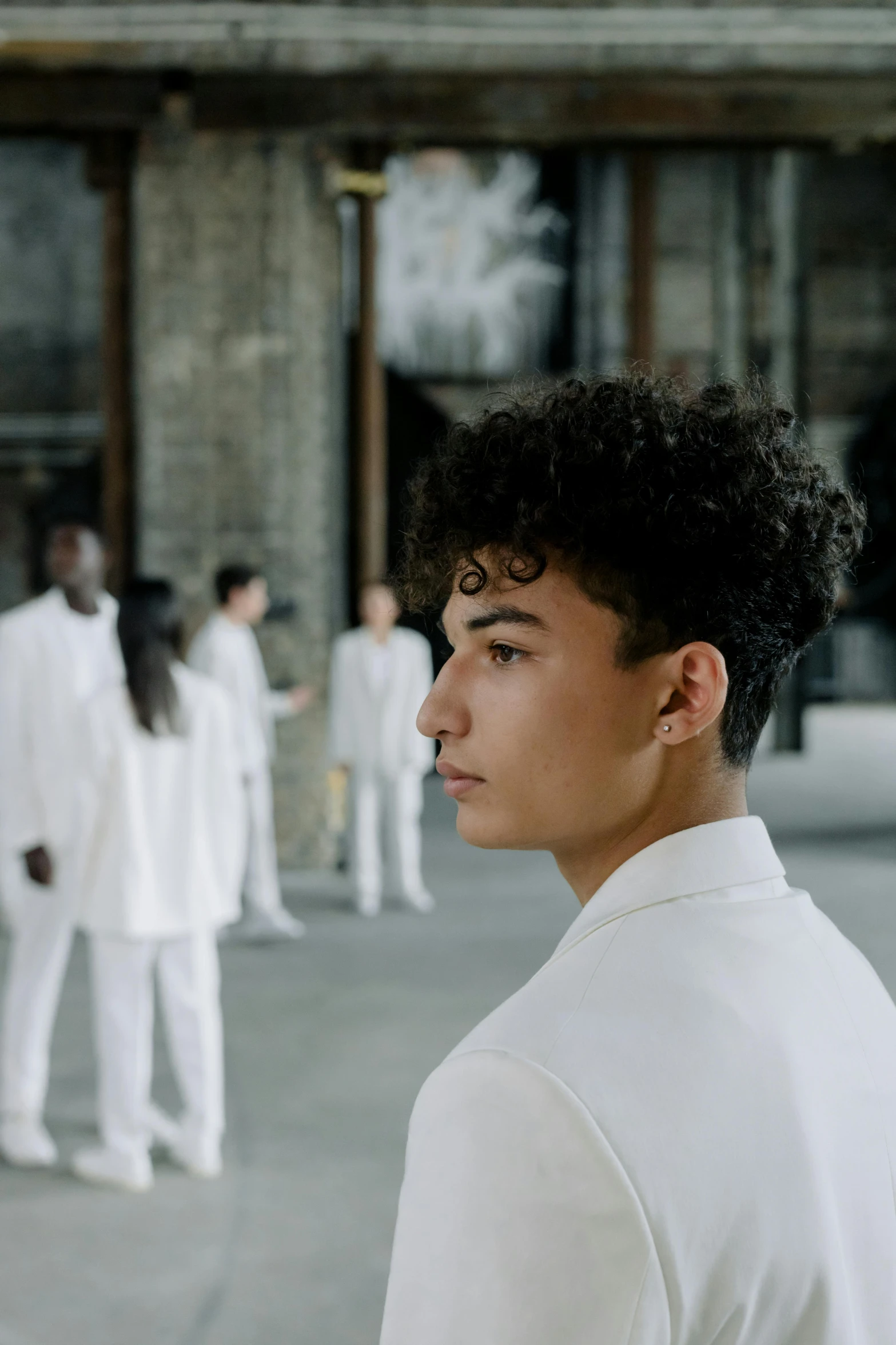 a group of people standing in white clothes