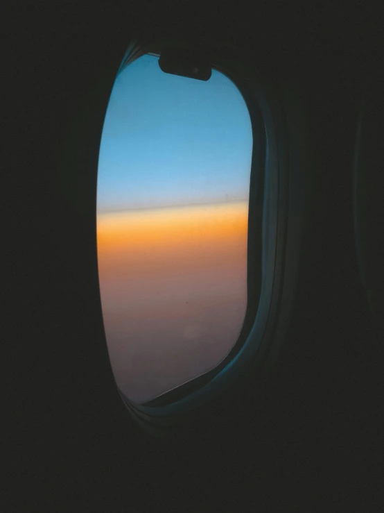 an airplane window with the view of the sky
