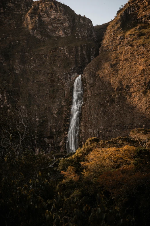 a waterfall that is sitting in the middle of a field