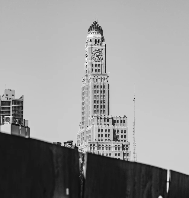 a tall building sitting next to a very tall city