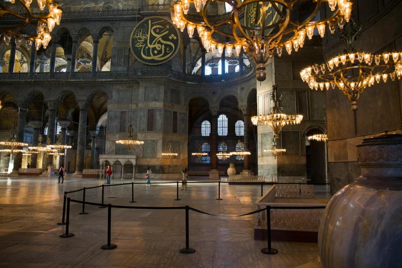 an ornate room in a mosque with chandeliers