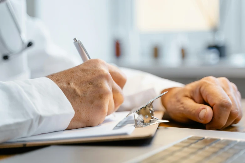 a person with a pen on a clipboard and paper