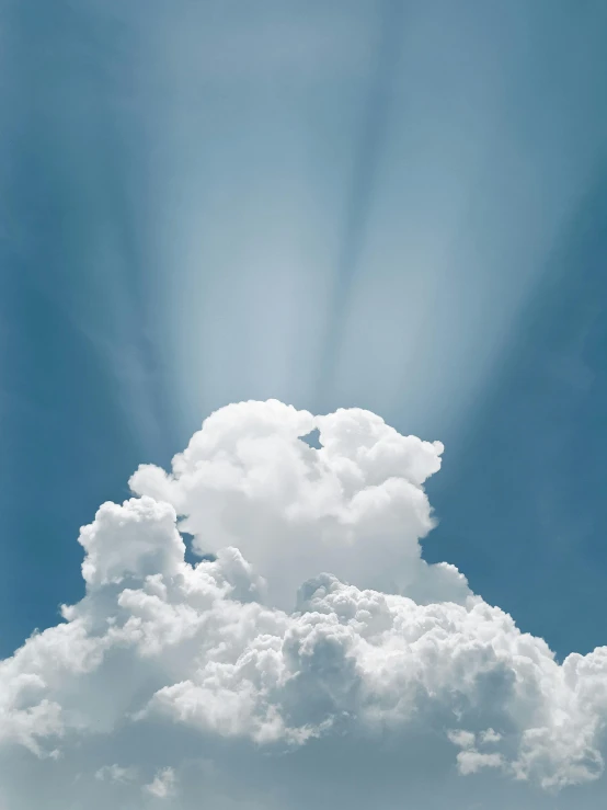 sun rays pass through the clouds over a beach