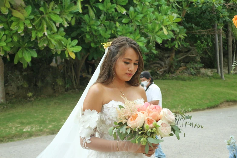 a bride is holding her bouquet in front of the camera