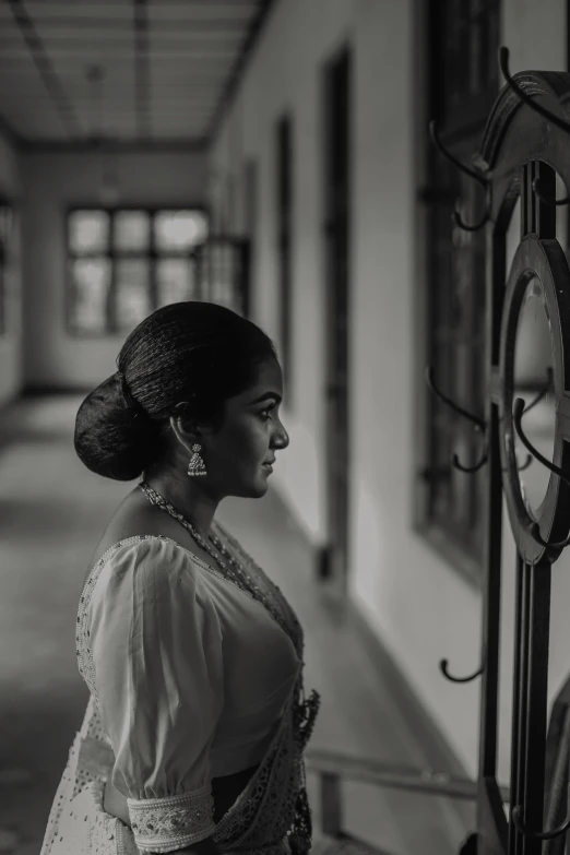 a woman is standing next to a clock