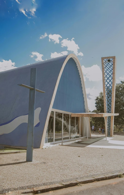 an artisticly designed building against a cloudy blue sky