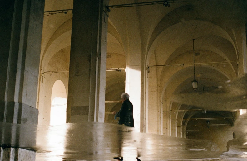 a couple of people walking through an empty building