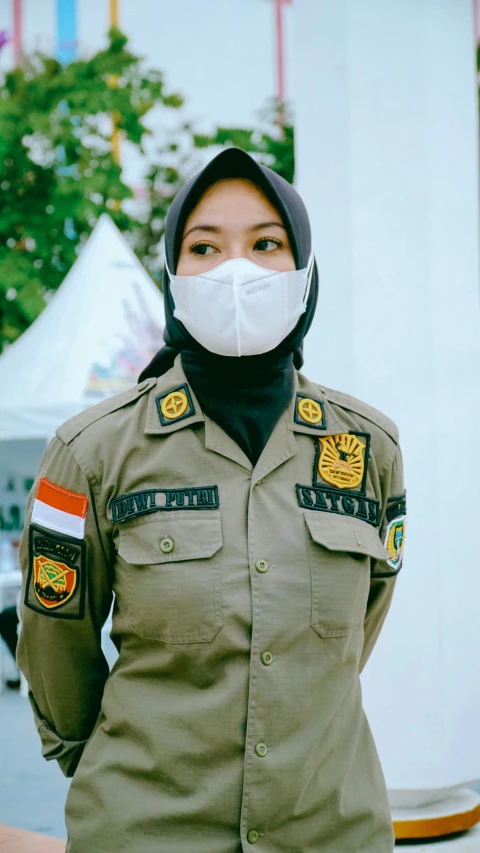 a female police officer wears a surgical mask