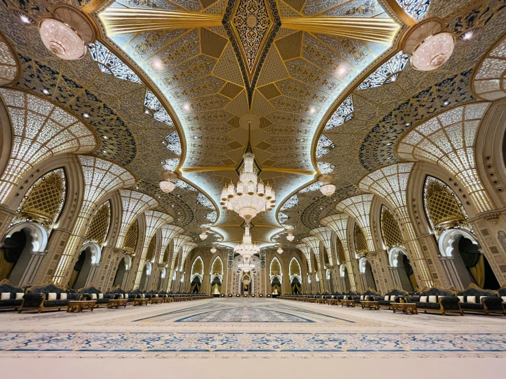 the inside of an ornate building that is mostly gold and blue