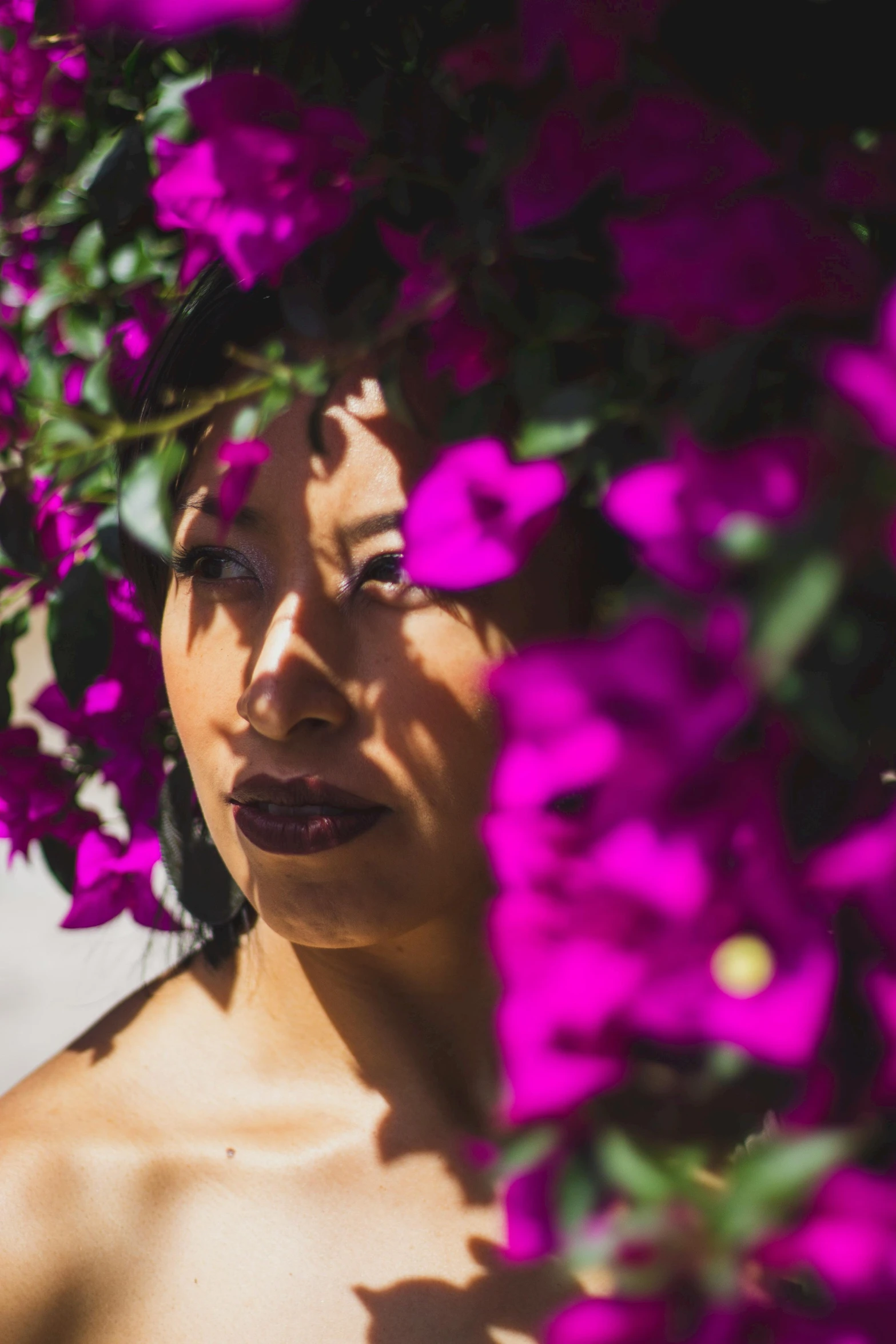 there is a woman that is standing next to flowers