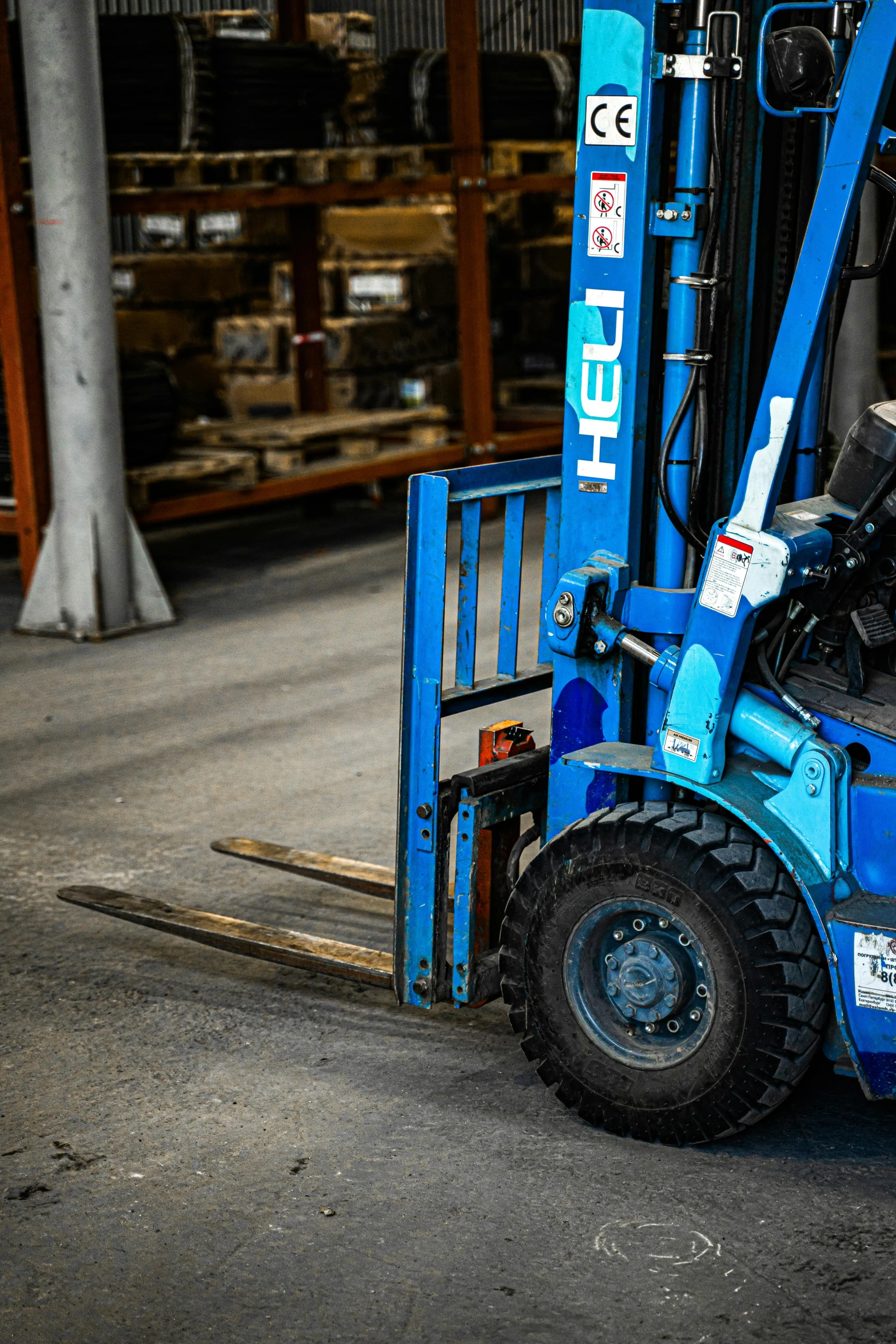 a person on a blue forklift moving items