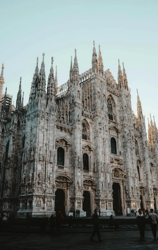 a very big and fancy building with people in front of it