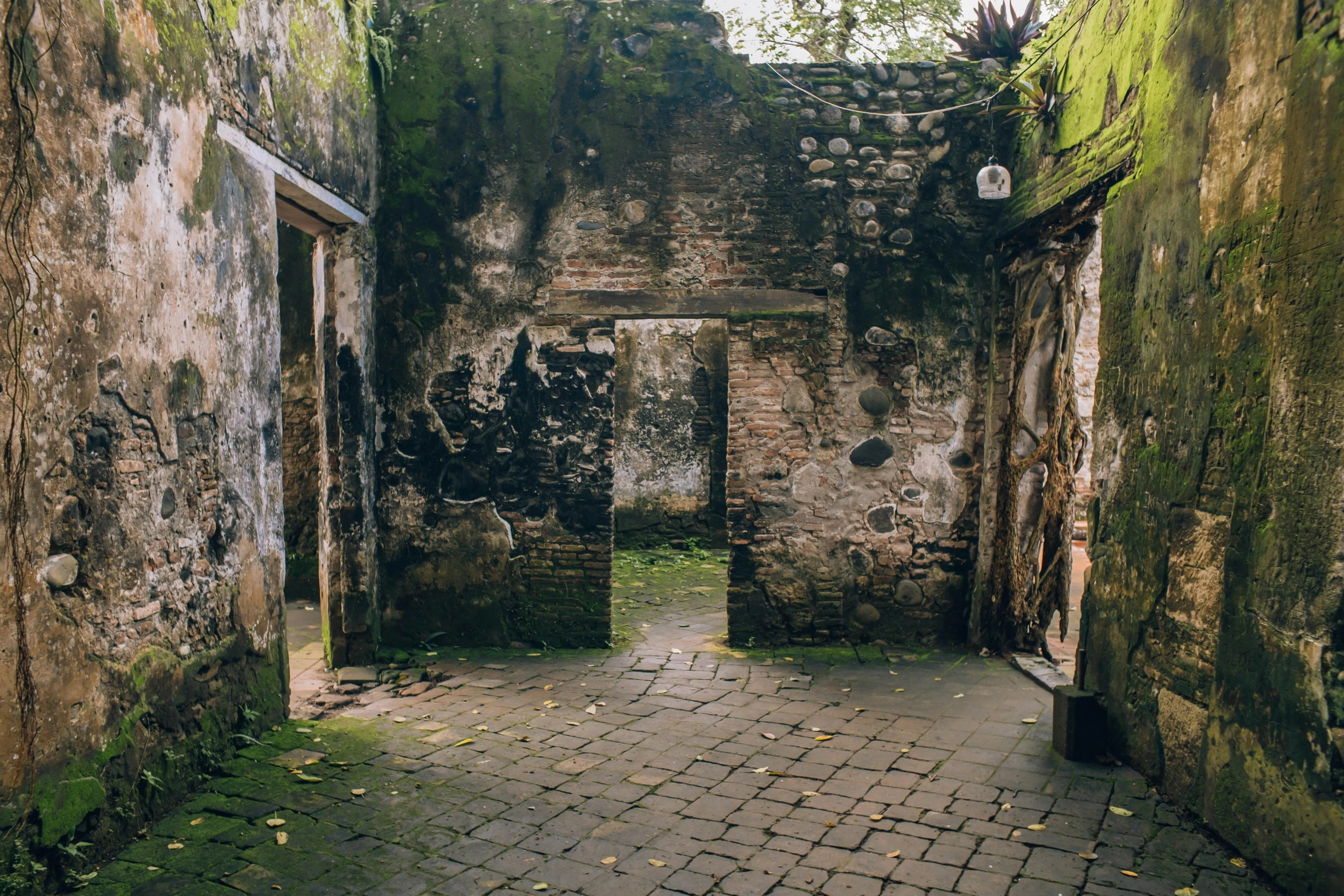 an old and rusty looking building with two open doors