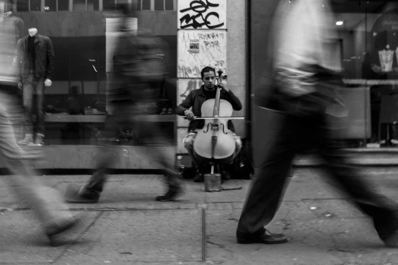 a man with a bass on the street near another person walking by