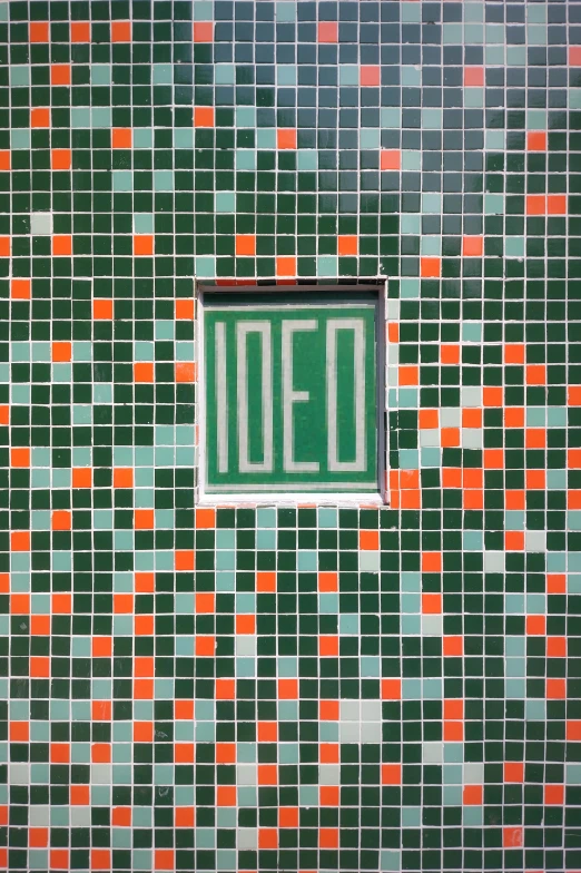 the bathroom has colorful wall tiles covering it