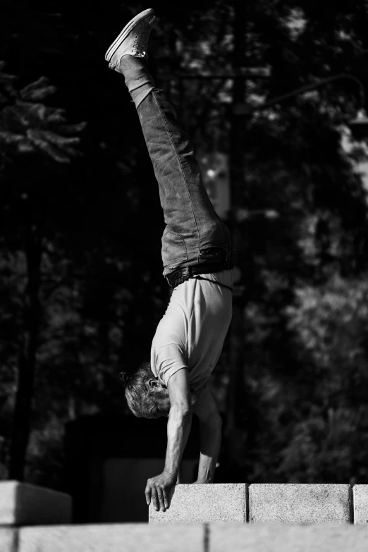 a man doing a handstand in the air outside