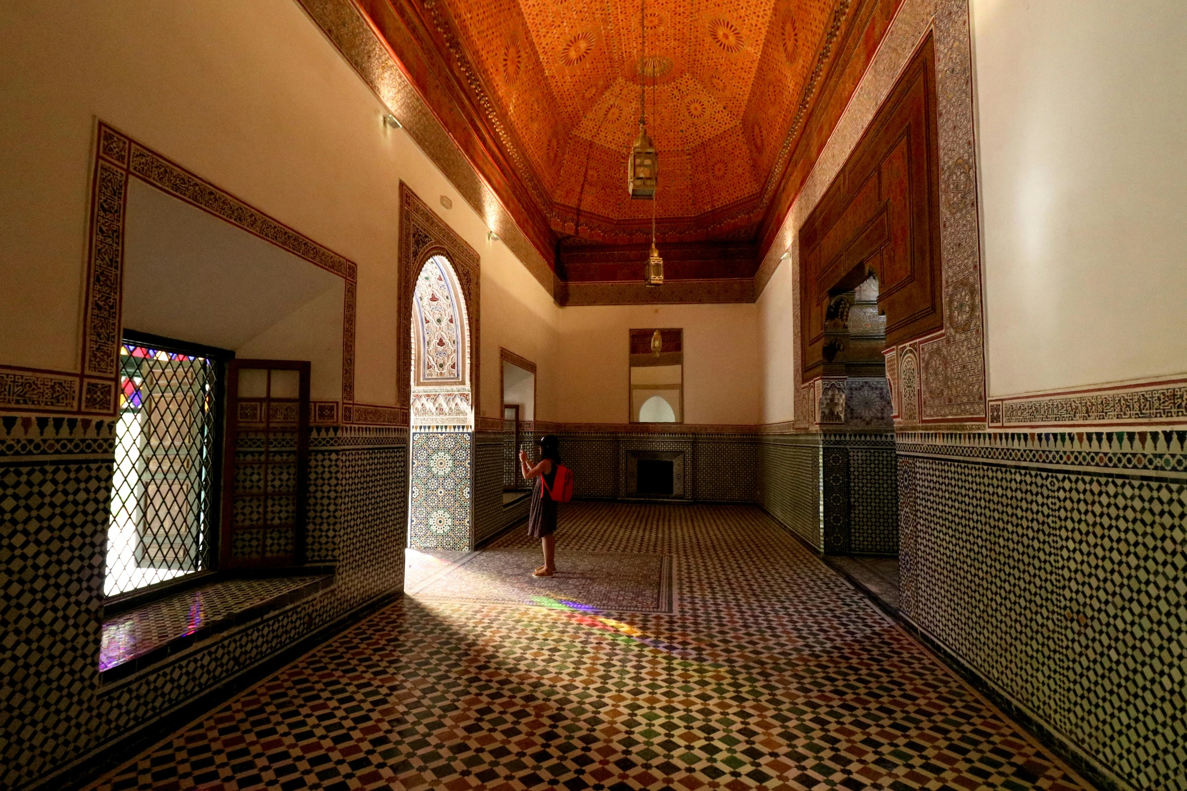 a large hallway with an intricate ceiling and tiled floors