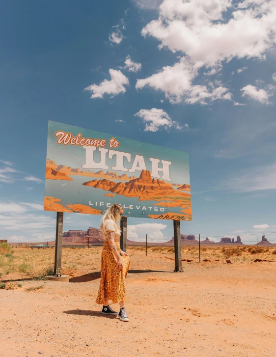 a person standing in front of a large poster on a sign