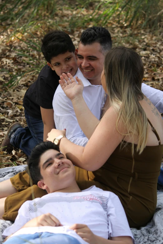 a man covering his mouth in the middle of three people