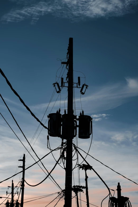 telephone wires are covered by wires against the sky