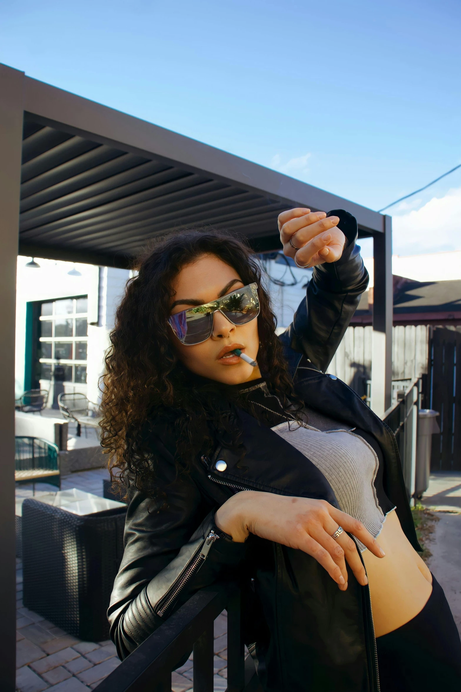 a woman wearing sunglasses taking pictures in her camera