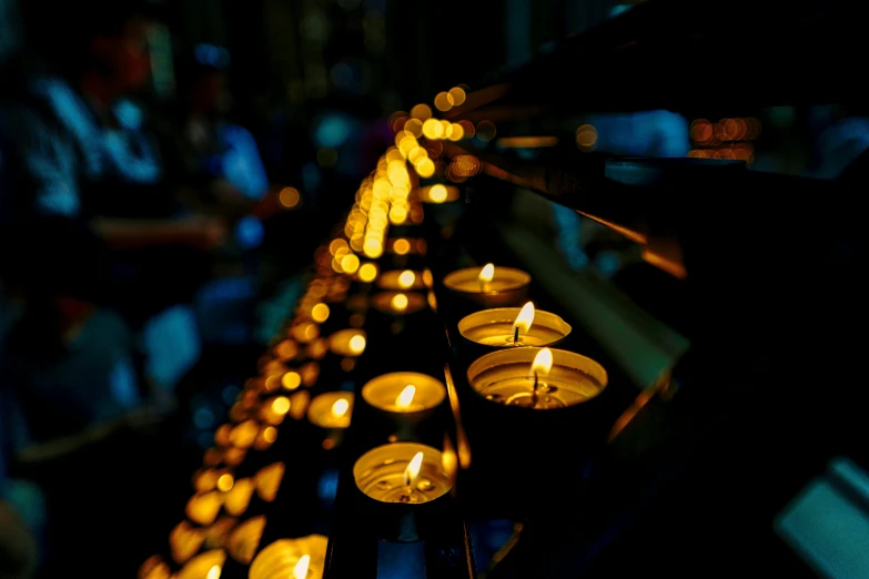 lit candles line the top of a wall