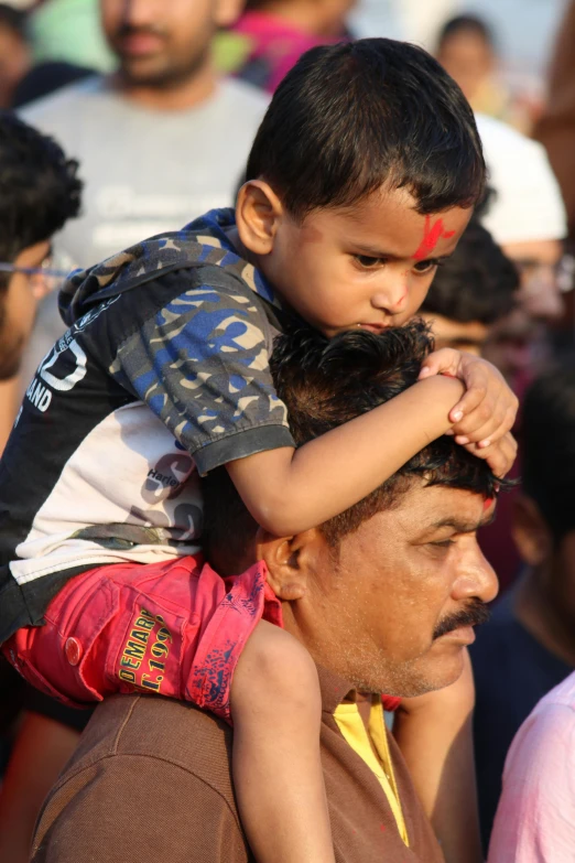 an adult holding a child on his back