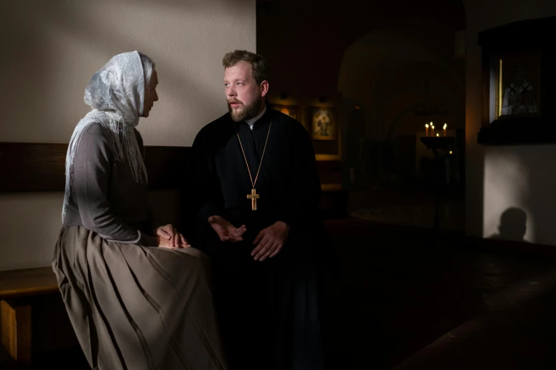 a man and woman are talking together in the church