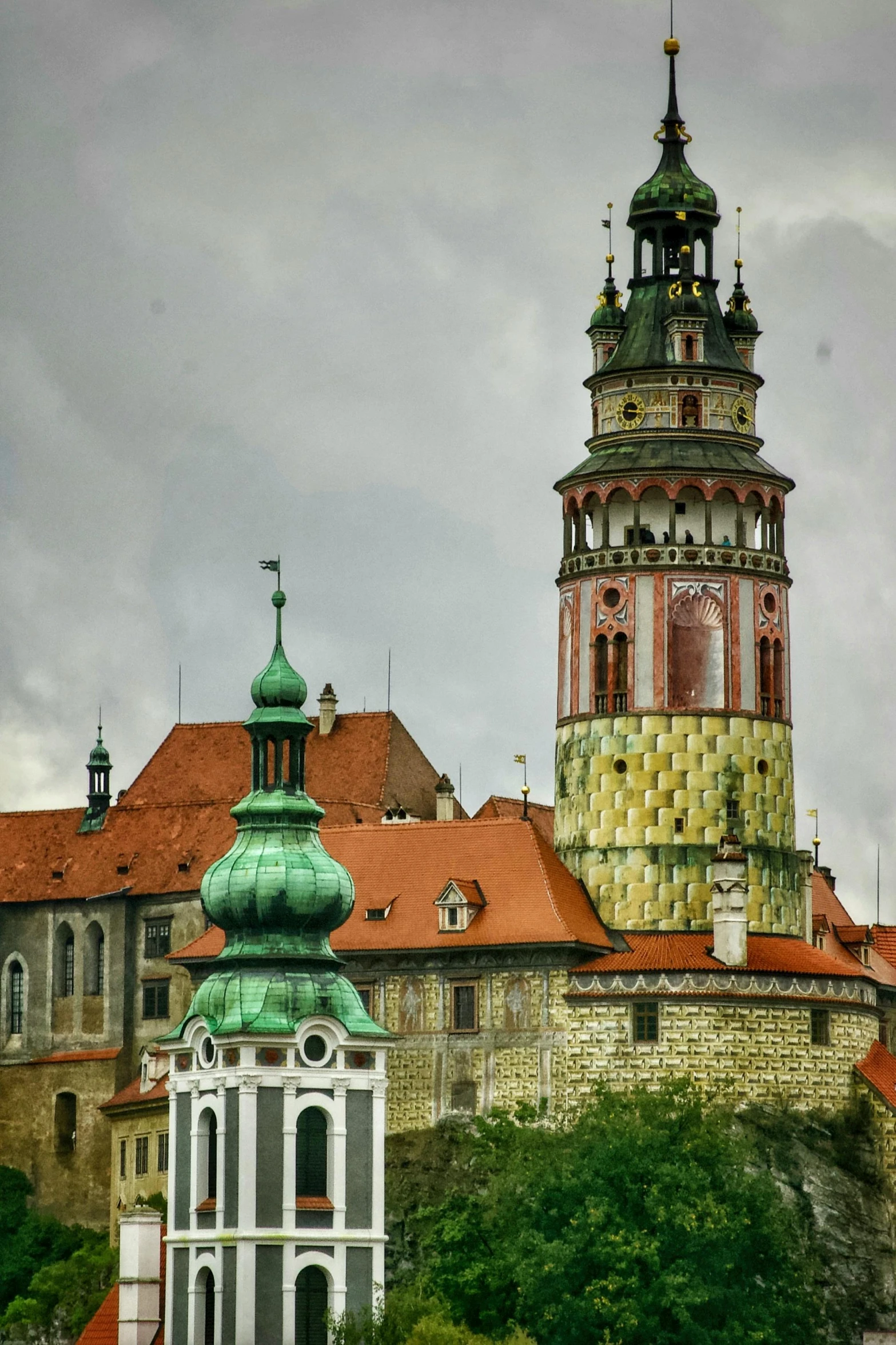 the tower of a building stands above other buildings