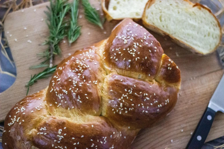 close up view of a loaf of bread with sagel sprigs on top