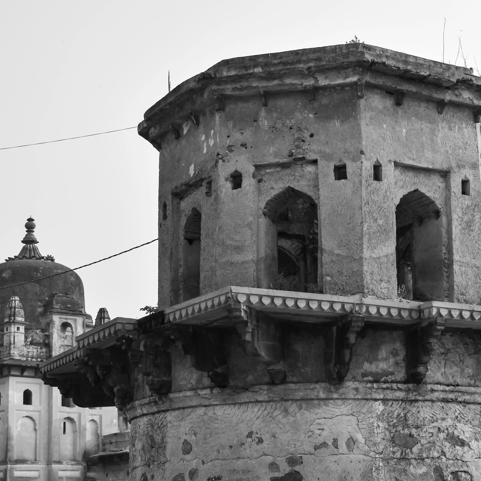 a black and white picture of the top of a tall building with domes