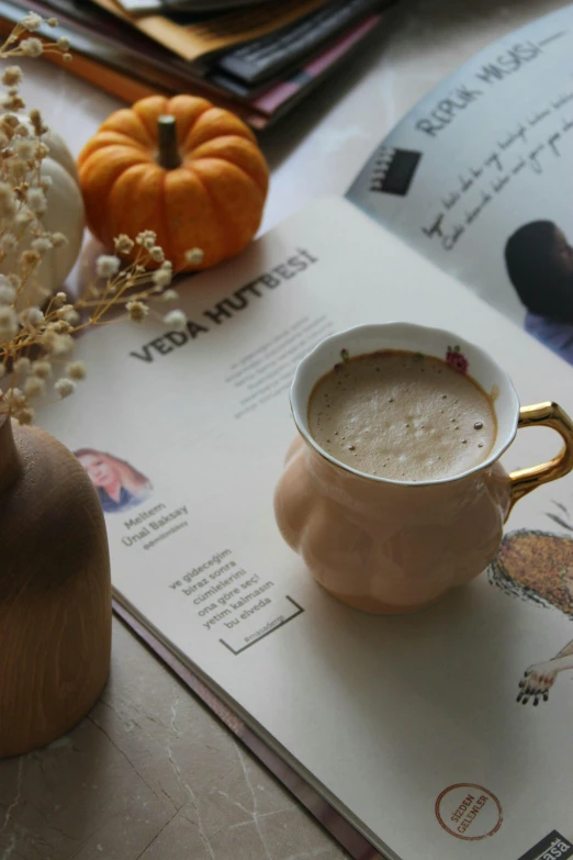 an empty white coffee cup sitting on top of a table