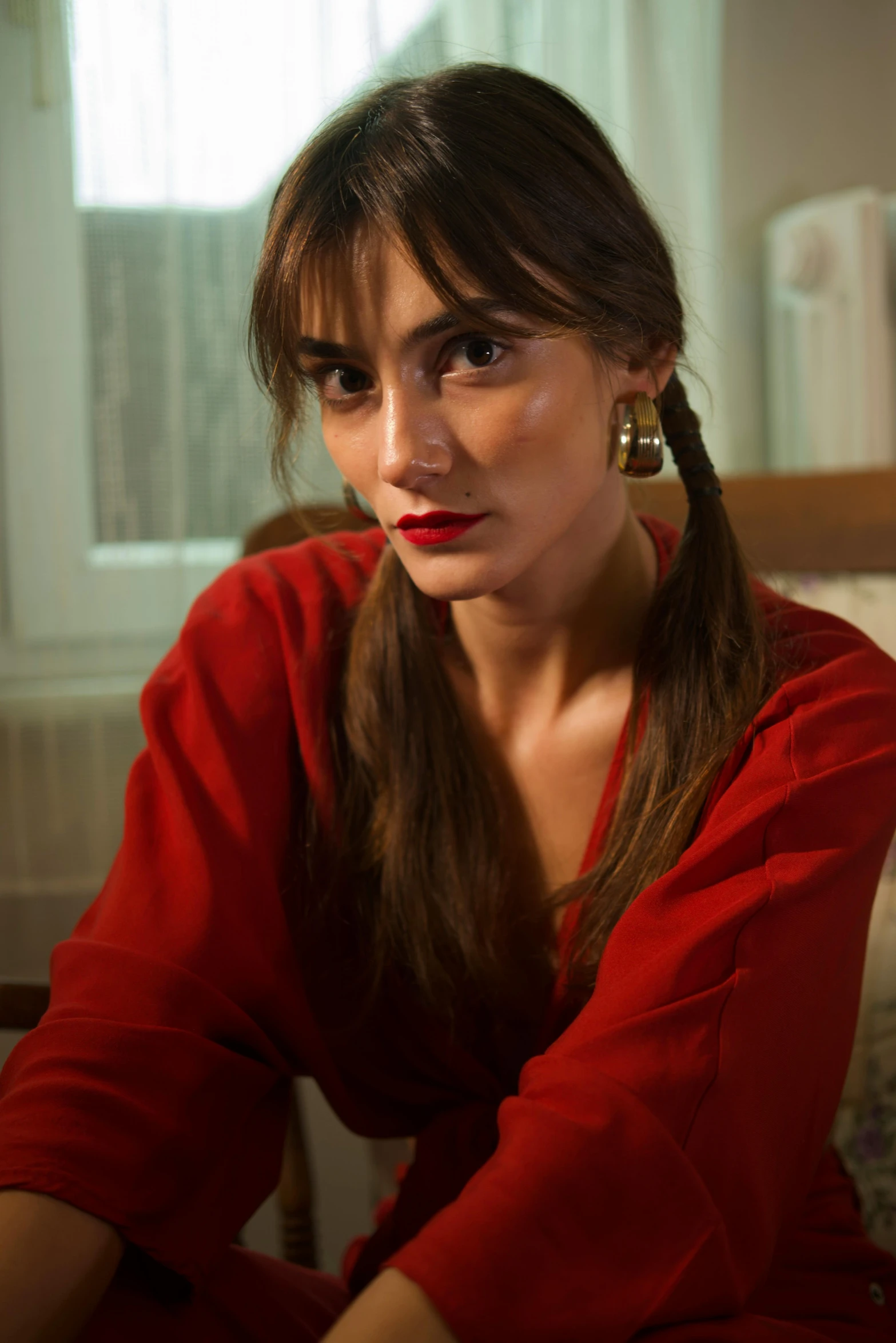 a woman sitting on the ground with a red shirt