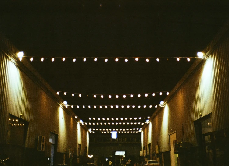 a street that has some lights strung up on the walls