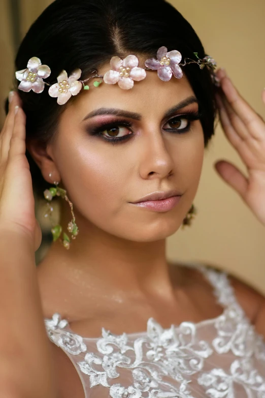 a woman with flowers on her head and makeup