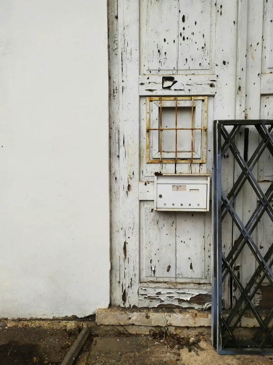 a door and window are seen near a run down building
