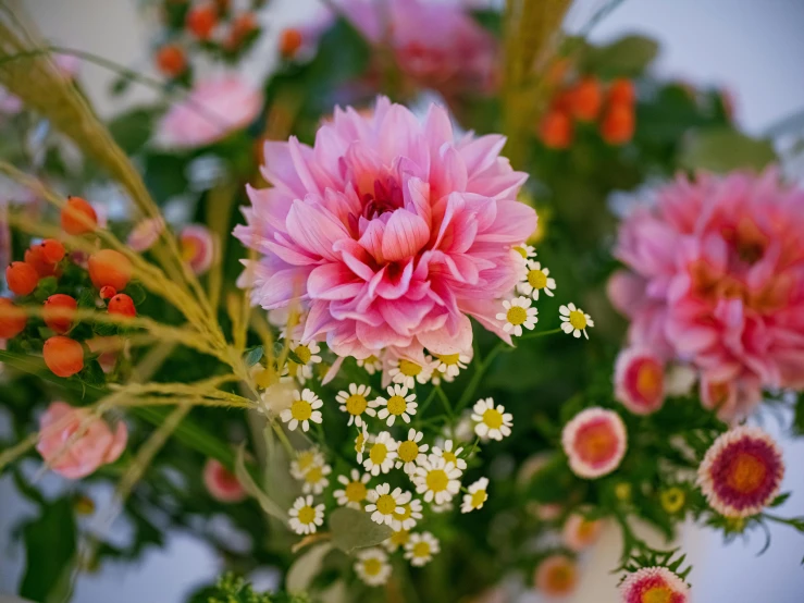 a bunch of pink and white flowers in a vase