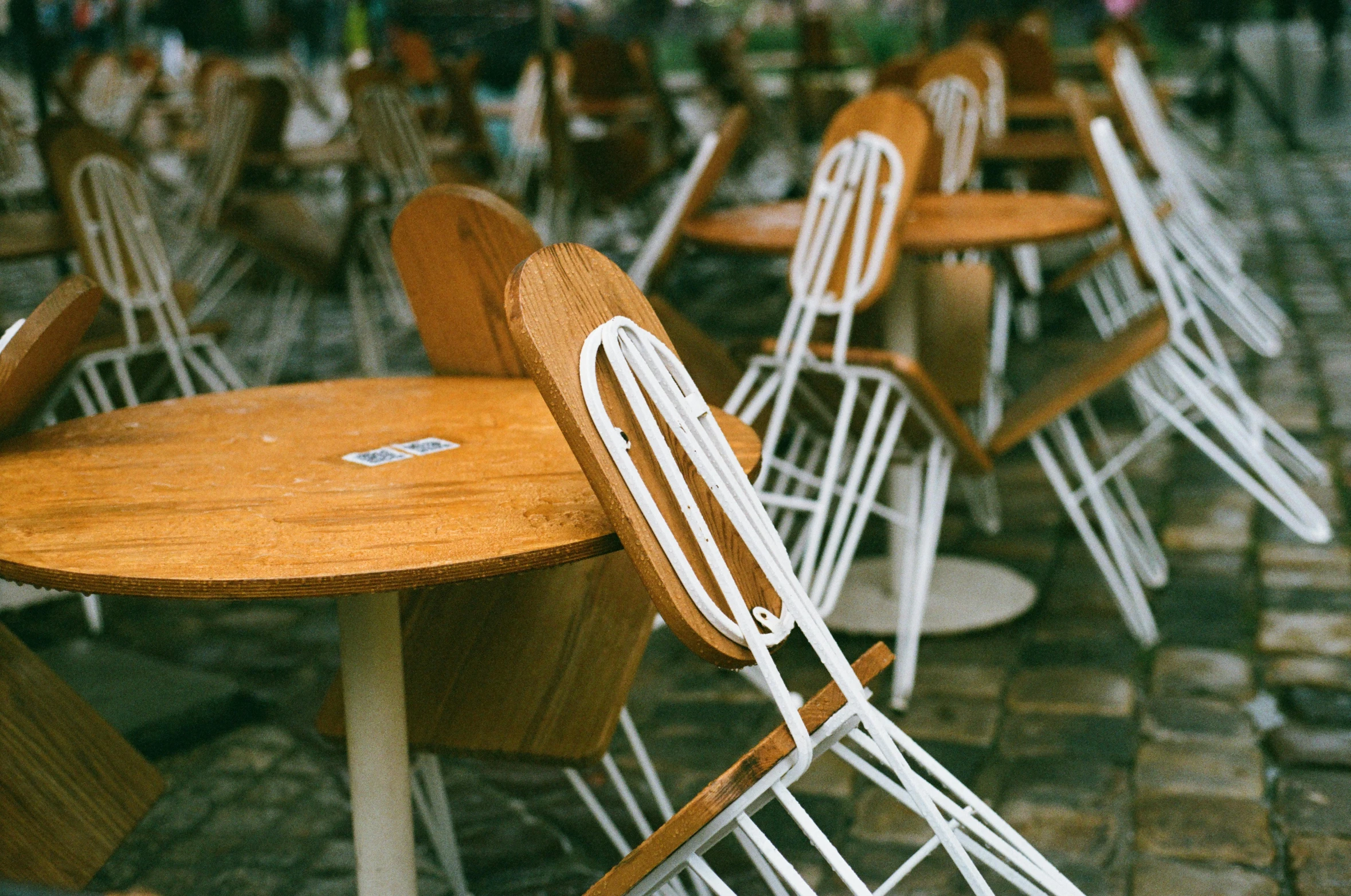 four tables with chairs and a few chairs around it