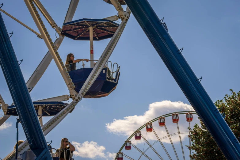 a person rides the carnival wheel in an amut park