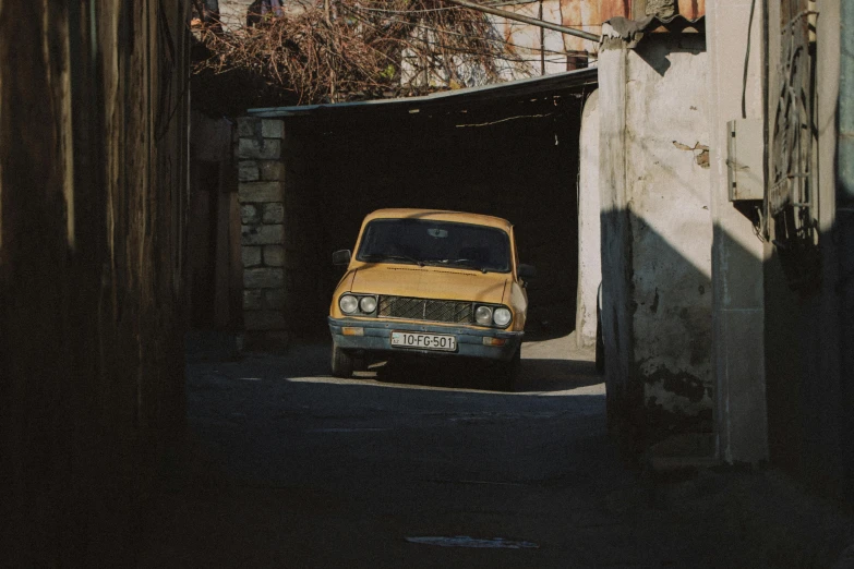 a small car is parked by some buildings