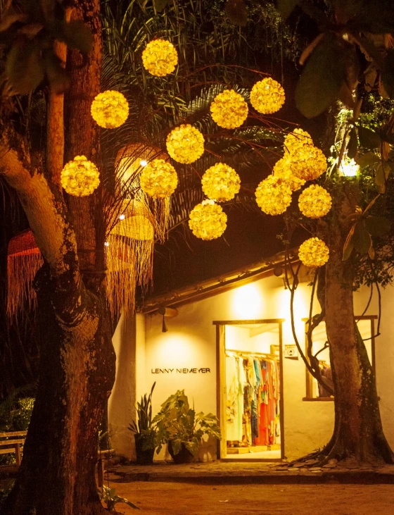 a bunch of yellow lights strung from the side of a building